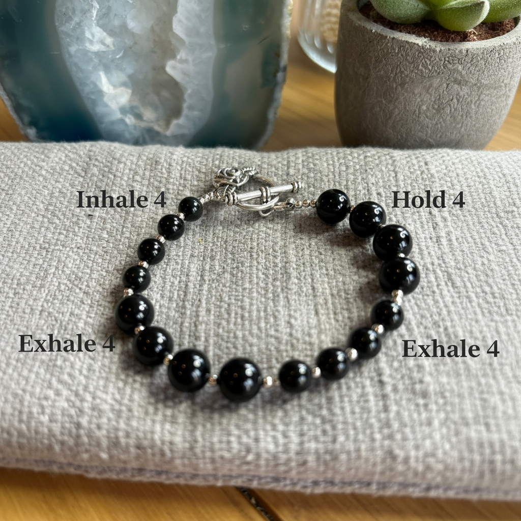 Obsidian breathwork bracelet showing alternating 8mm and 6mm bead groups labelled for box breathing: Inhale 4, Hold 4, Exhale 4, Hold 4