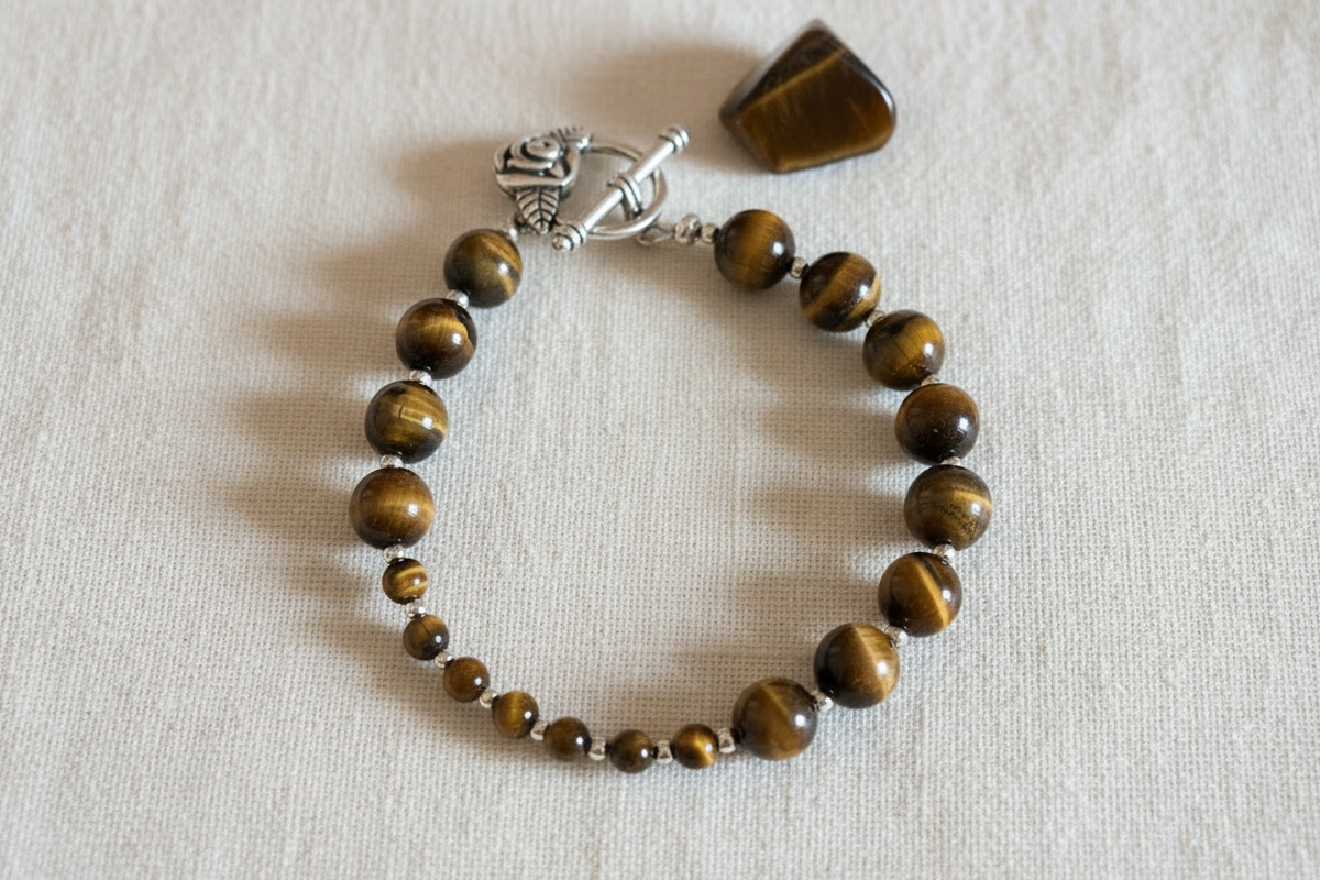 Tiger's eye breathwork bracelet on cream cotton background